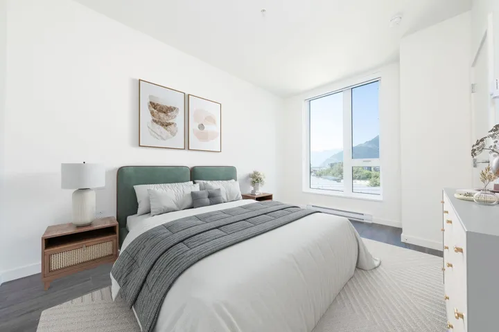 Bedroom featuring wood finished floors, a baseboard radiator, and a mountain view