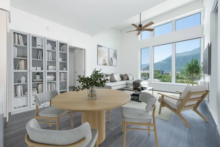 Dining room with a ceiling fan, wood finished floors, and a towering ceiling