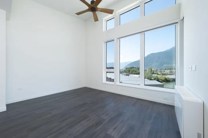 Spare room featuring a mountain view, ceiling fan, and dark wood-type flooring