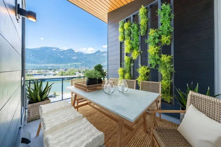 Balcony with outdoor dining space and a water and mountain view