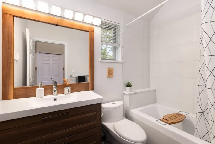 Full bath featuring vanity and shower / bath combination with curtain