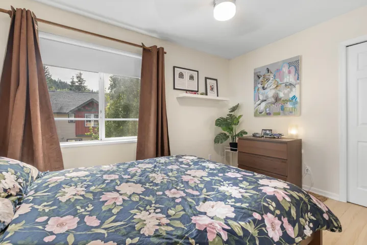 Bedroom with wood finished floors and ceiling fan