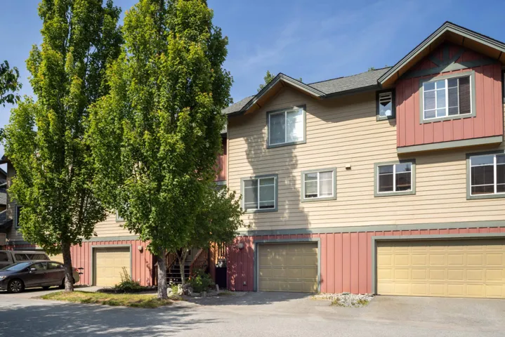 View of front of home with a garage, driveway, and board and batten siding