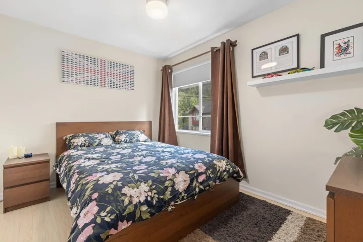 Bedroom featuring wood finished floors and baseboards