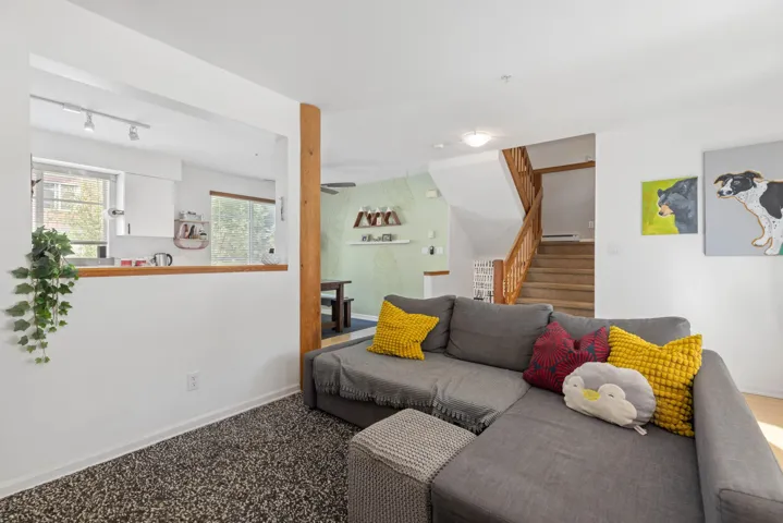 Living room featuring stairs and track lighting