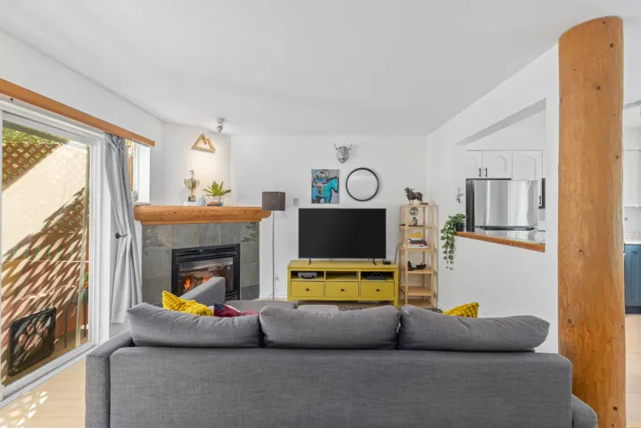 Living area featuring a tiled fireplace and wood finished floors