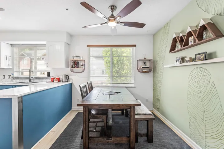 Dining space with a ceiling fan and wood finished floors