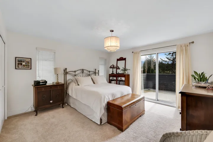 Bedroom featuring access to outside and light colored carpet