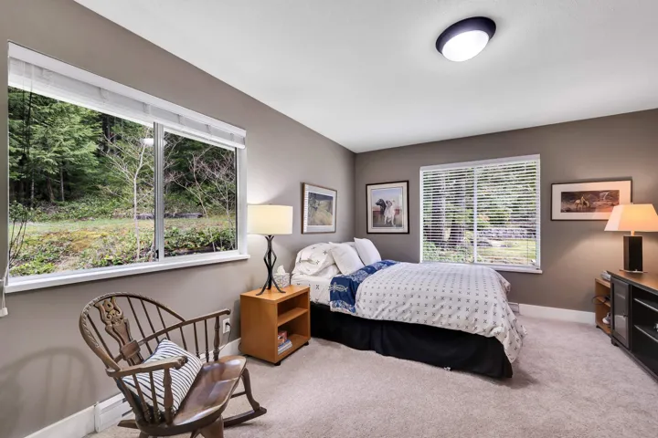Bedroom with baseboards and light colored carpet