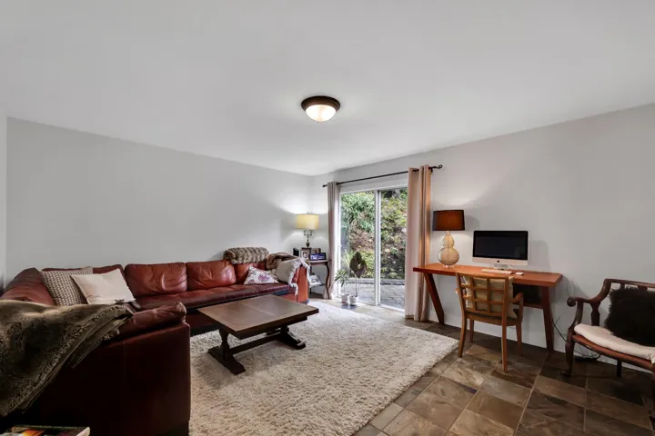 Living area with stone finish floors and an office area