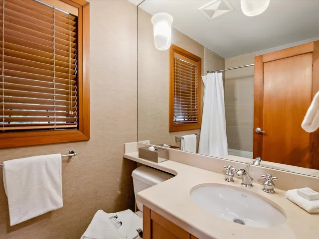 Washroom featuring stacked washer and dryer, stone finish floor, and laundry area