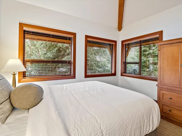 Bedroom featuring lofted ceiling and baseboards