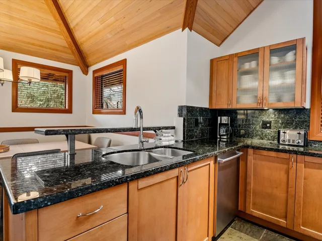 Dining area featuring wood ceiling, baseboards, stone tile floors, and a wealth of natural light