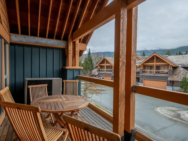 Kitchen with a chandelier, wood ceiling, a sink, and a stone fireplace