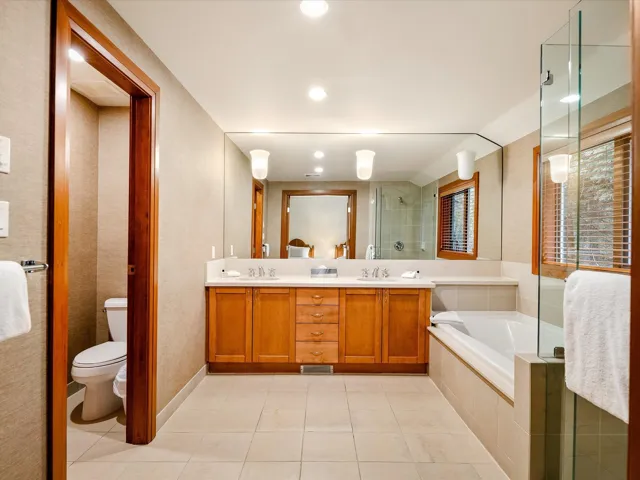 Bedroom featuring connected bathroom and light tile patterned floors
