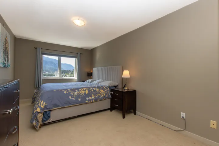 Carpeted bedroom featuring baseboards