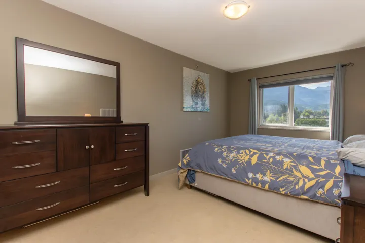 Bedroom with light carpet and baseboards