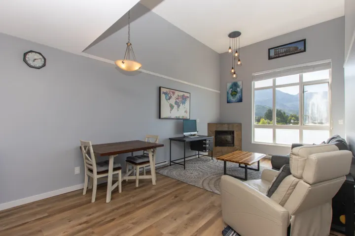 Living room with wood finished floors and a tile fireplace