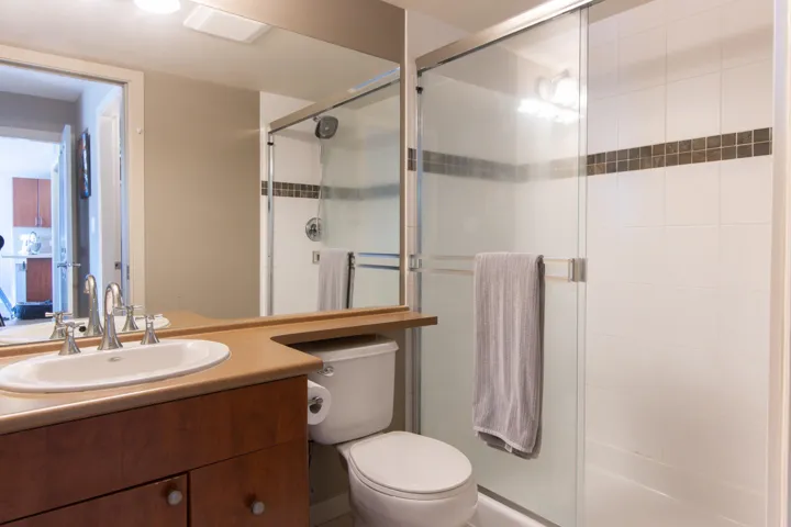 Bathroom featuring vanity and a shower stall