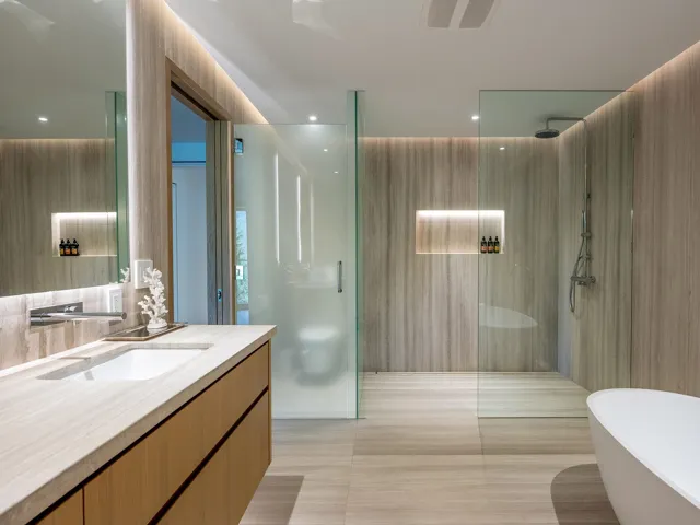 Bathroom with a walk in shower, vanity, a freestanding tub, and light tile patterned floors