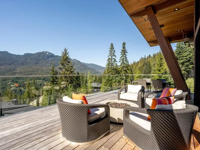 Wooden deck with outdoor lounge area, a mountain view, and a forest view