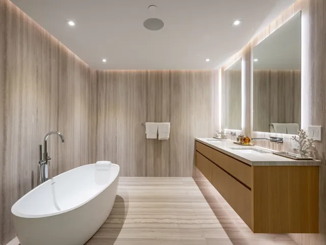 Bathroom featuring a soaking tub, double vanity, and recessed lighting