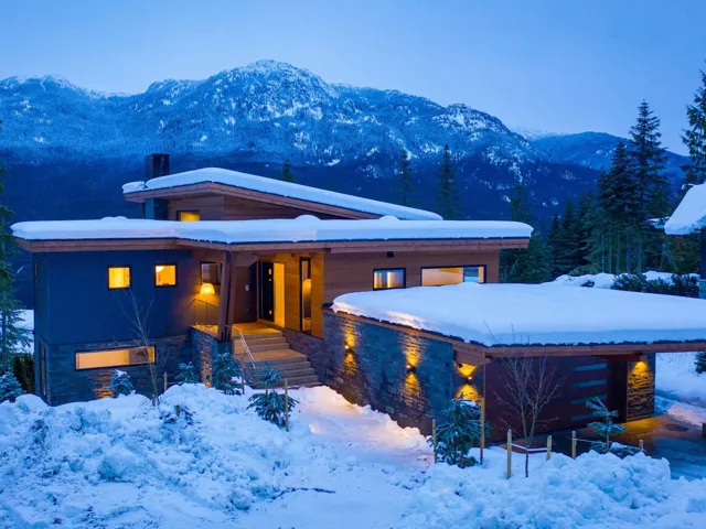 Contemporary home featuring covered porch, a chimney, and a mountain view