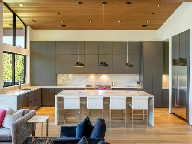 Kitchen featuring decorative light fixtures, light wood-style floors, light stone countertops, a kitchen island, and wooden ceiling