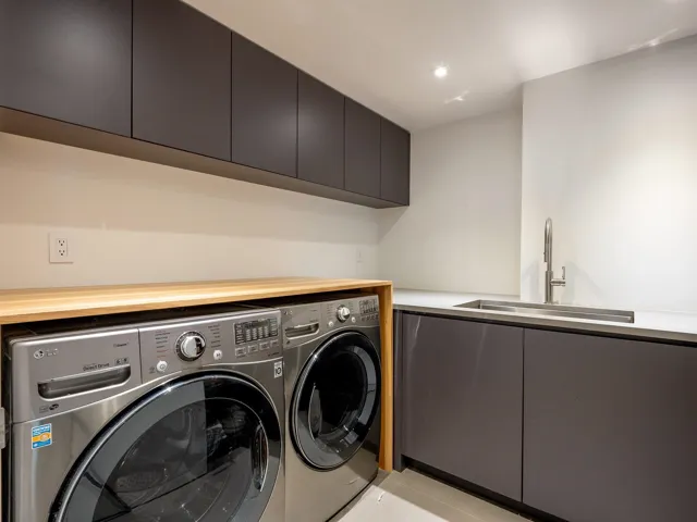 Washroom with light tile patterned floors, cabinet space, and separate washer and dryer