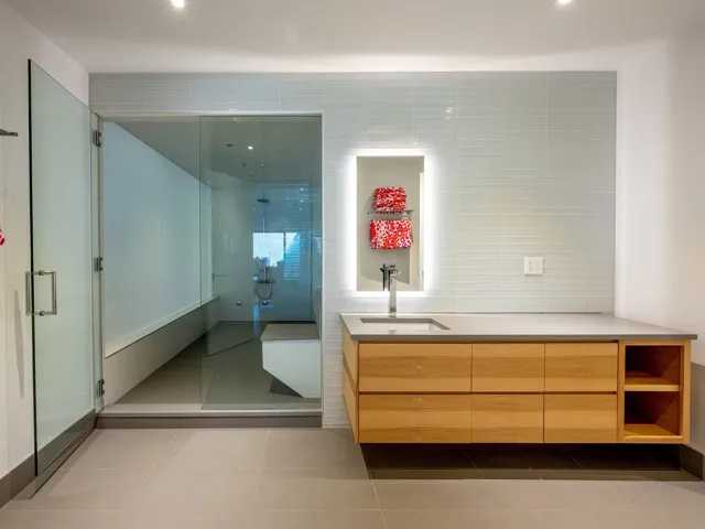 Full bathroom with vanity, light tile patterned flooring, a shower stall, and tile walls