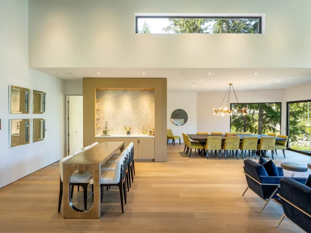 Dining area featuring plenty of natural light, light wood-type flooring, a high ceiling, a chandelier, and recessed lighting