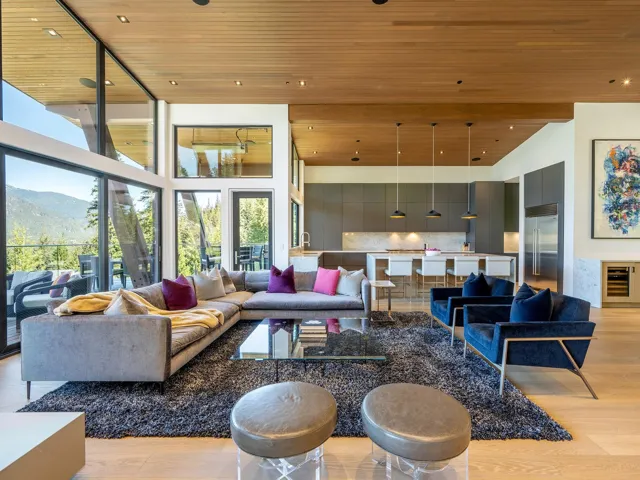 Community lobby featuring wood ceiling, a towering ceiling, a mountain view, and recessed lighting