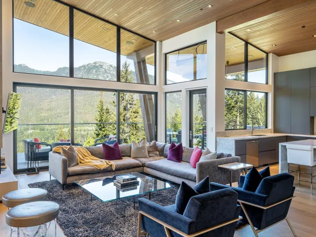 Building lobby featuring wooden ceiling, a towering ceiling, a mountain view, and recessed lighting
