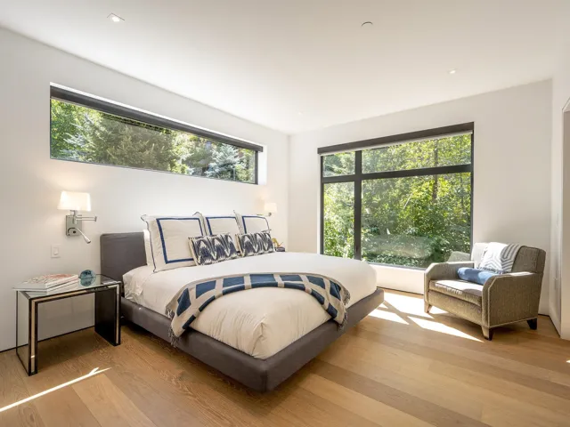Bedroom featuring multiple windows and wood finished floors