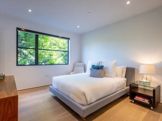 Bedroom with light wood-style floors and recessed lighting