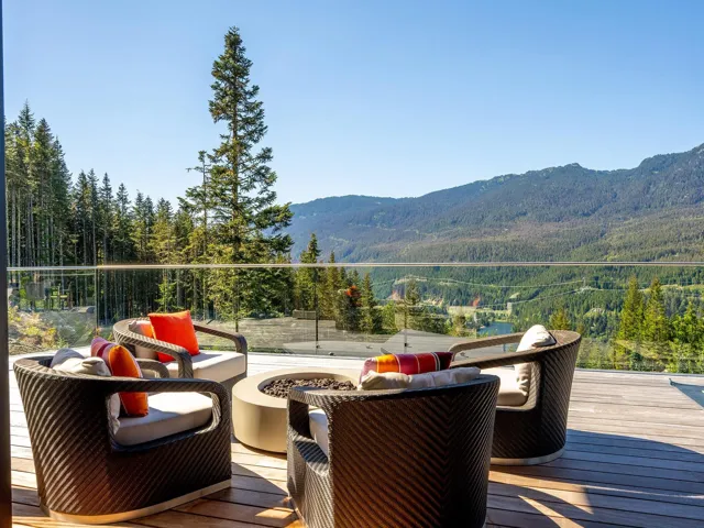 Wooden terrace with an outdoor living space with a fire pit, a view of trees, and a mountain view