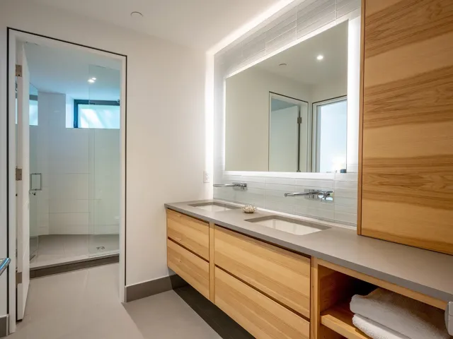 Bathroom with double vanity, a shower stall, light tile patterned floors, tasteful backsplash, and recessed lighting