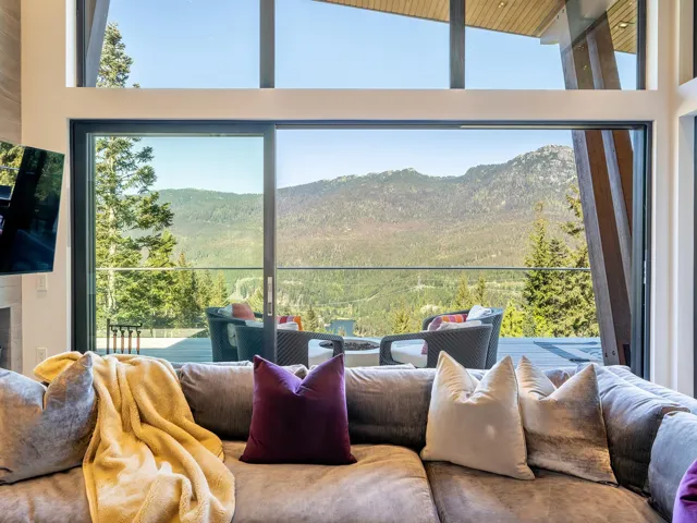 Sunroom with a mountain view, plenty of natural light, and a view of trees