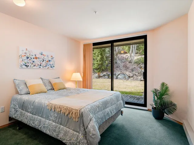 Bedroom featuring carpet, access to outside, and baseboards