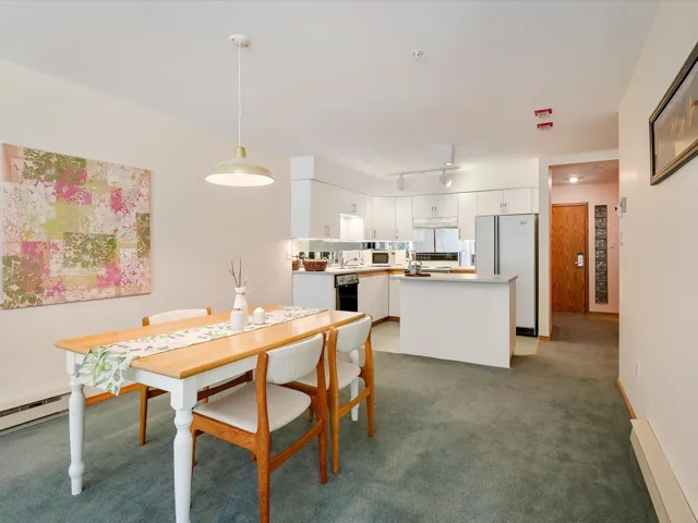 Dining area featuring baseboards, carpet flooring, and track lighting