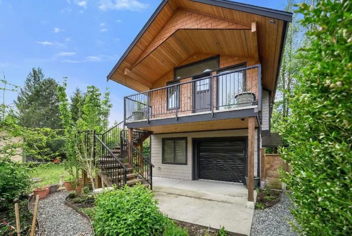 Rear view of house featuring a patio and stairs
