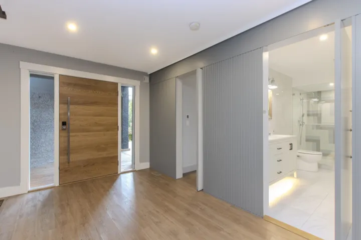 Foyer entrance with light wood-style floors and recessed lighting