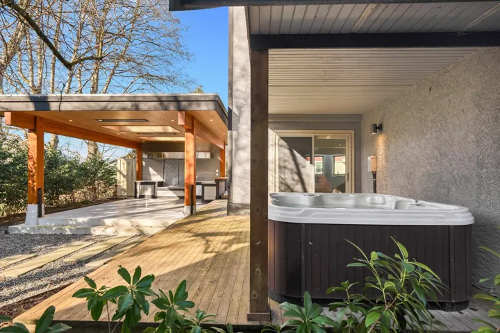 Wooden deck featuring a hot tub