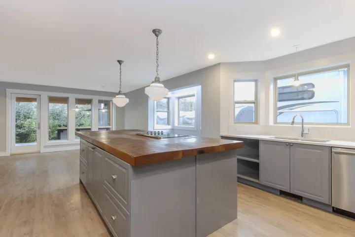 Kitchen featuring gray cabinetry, wooden counters, and a kitchen island