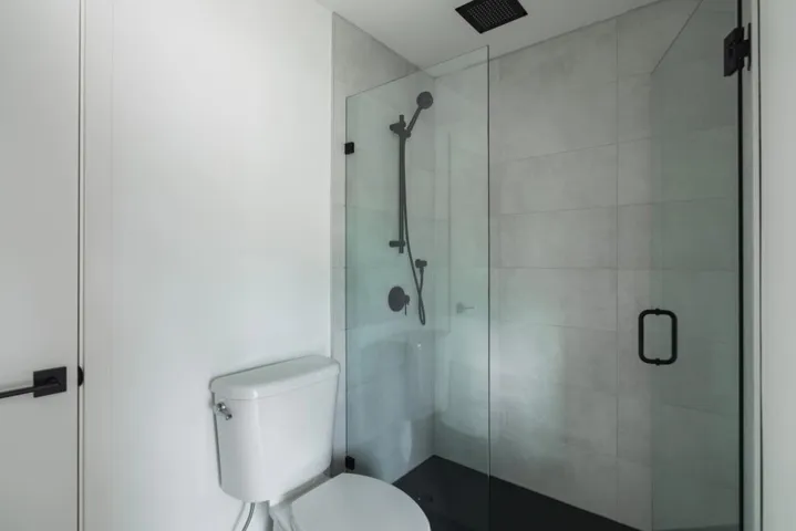 Bathroom featuring a stall shower and toilet