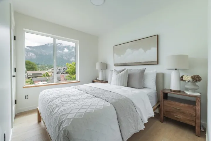 Bedroom featuring wood finished floors and baseboards