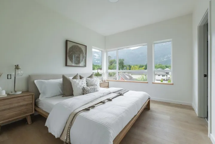 Bedroom with wood finished floors and a mountain view