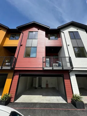 Back of property with a balcony and an attached garage