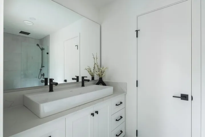 Full bathroom with double vanity and a tile shower