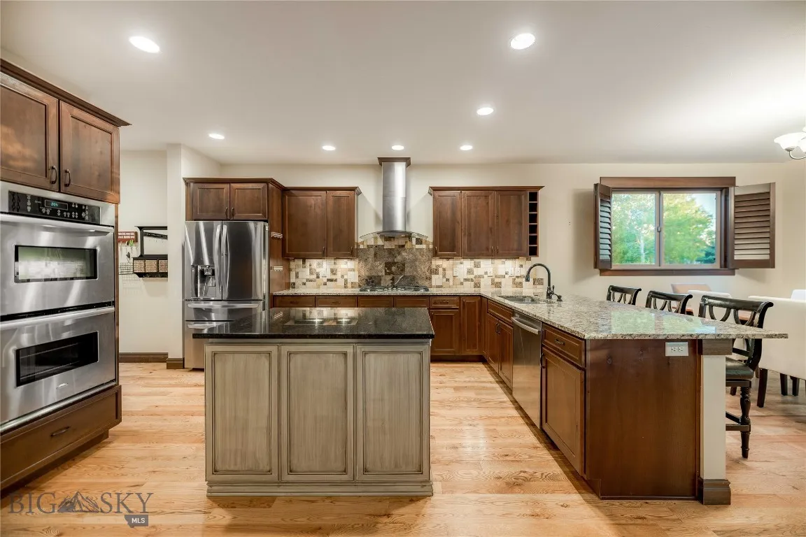 Large kitchen with Stainless appliances, cherry cabinetry and. granite countertops.